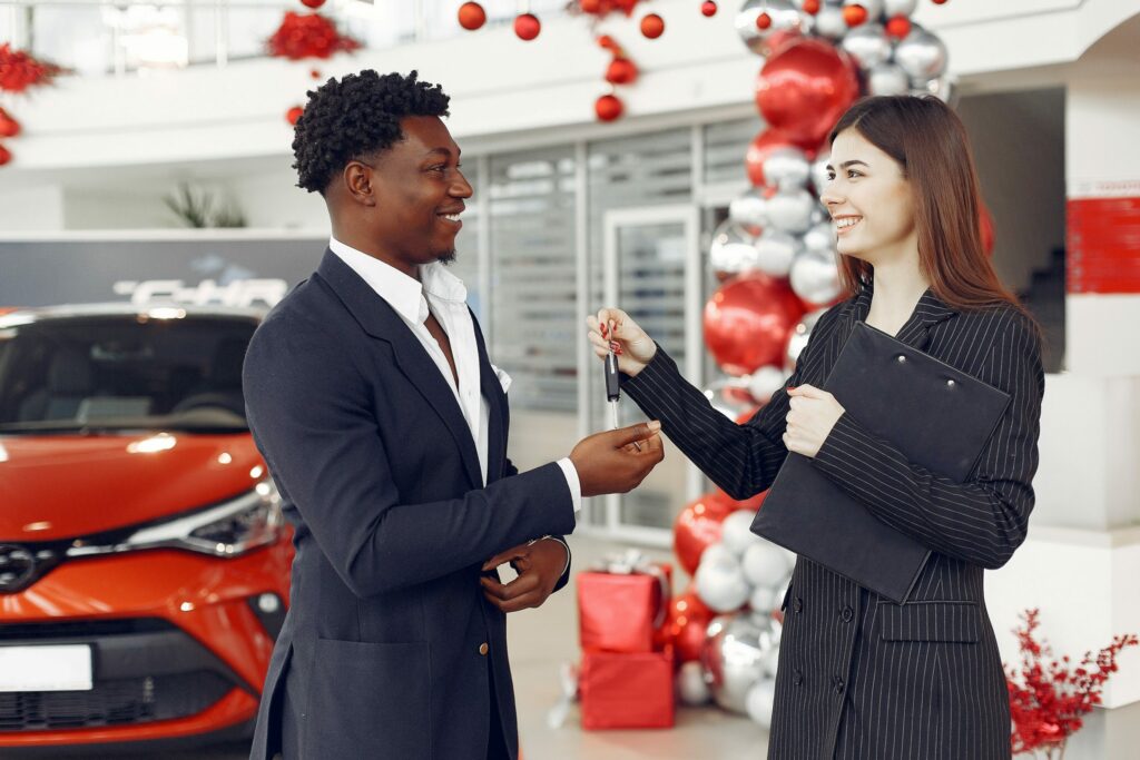 A man and a woman in business suits, completing a car title loan