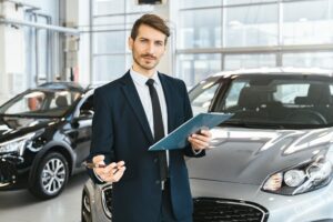 man holding a chart in front of a car
