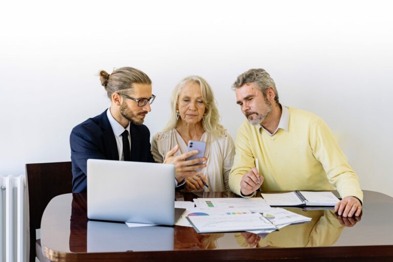 Man in suit showing car title loan options to old couple