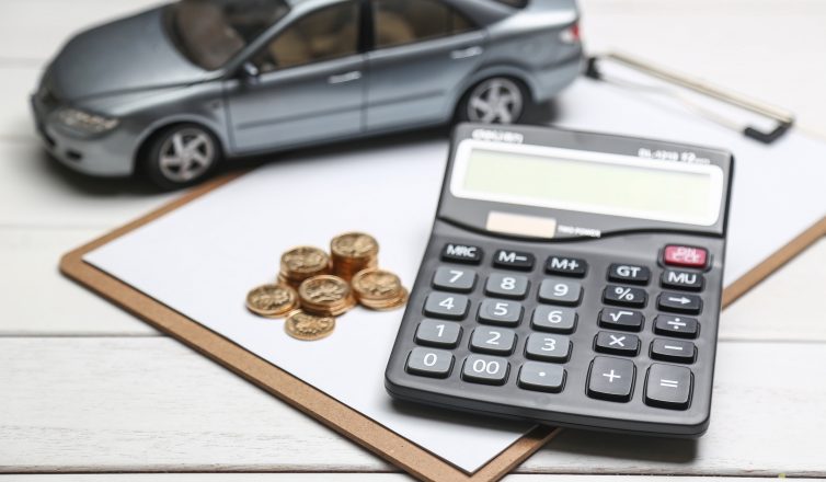 Car model, calculator, and coins on white table
