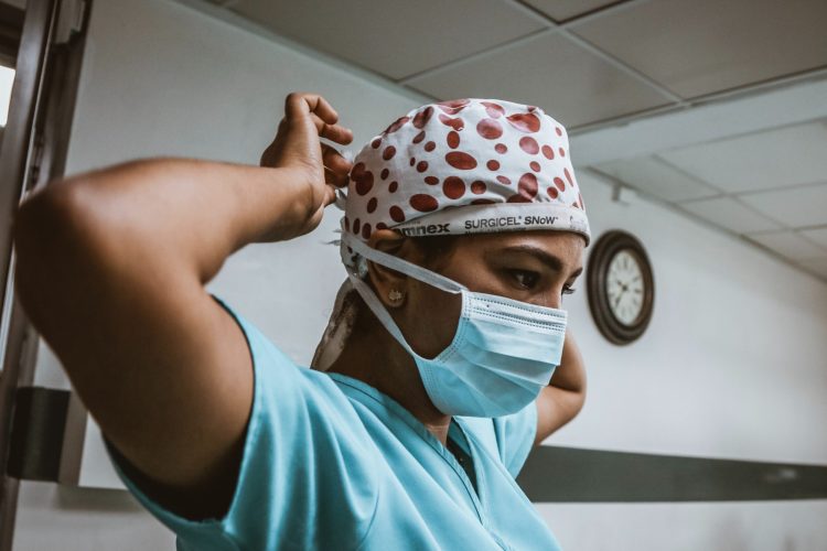 Healthcare worker in scrubs wearing a mask